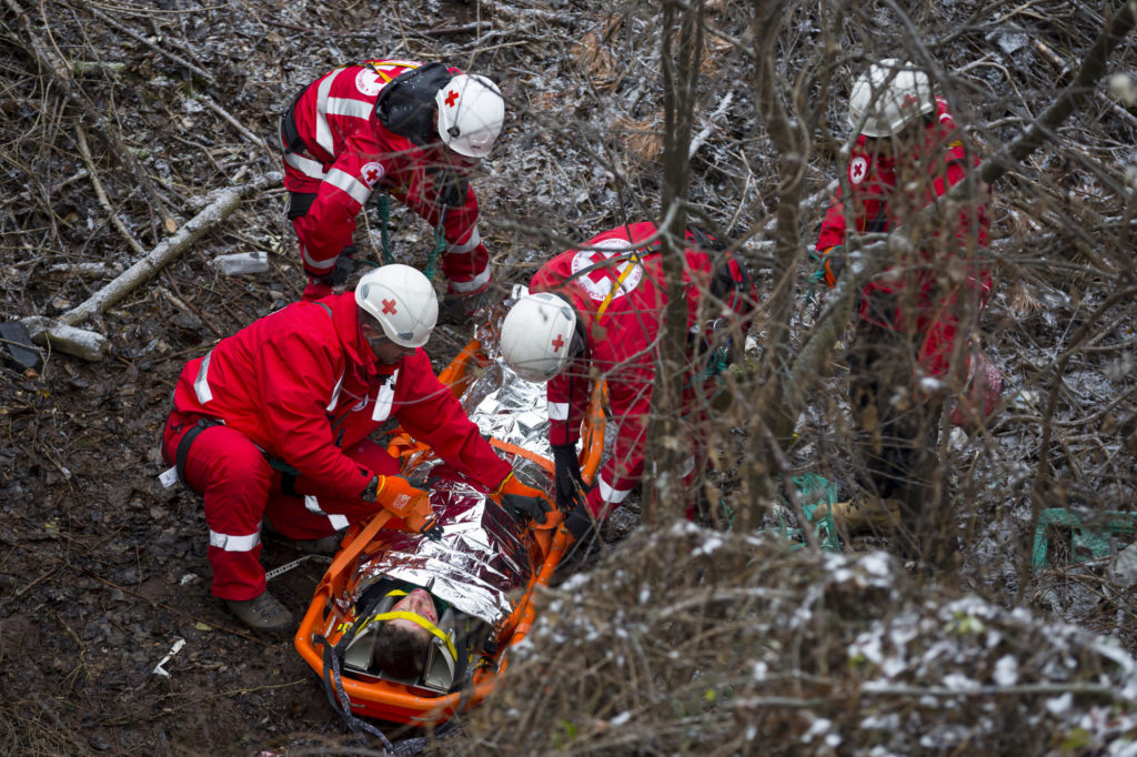 Sofia, Bulgaria - 5 December 2017: Paramedics from mountain rescue service provide first aid during a training for saving a person in accident in the forest.